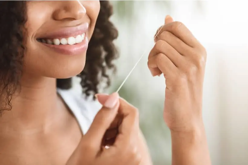 Para passar fio dental corretamente, primeiro é necessário cortá-lo em um tamanho de 40 cm, enrolar o fio nos dedos e deixar um espaço de 10 cm no meio